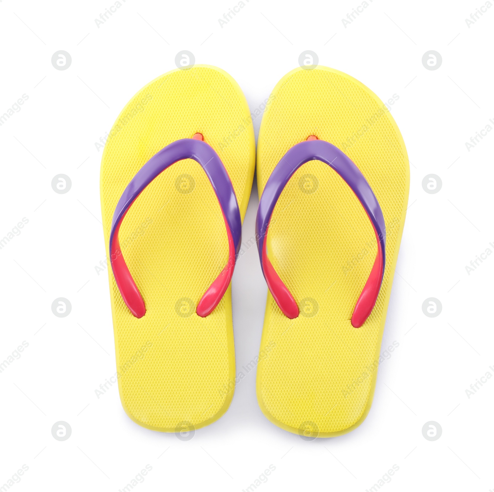 Photo of Pair of stylish yellow flip flops isolated on white, top view. Beach object