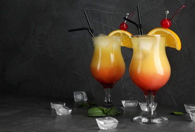 Photo of Just made appetizing cocktails Sex on the Beach, black background. Space for text