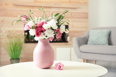 Photo of Vase with beautiful flowers on table in living room, space for text