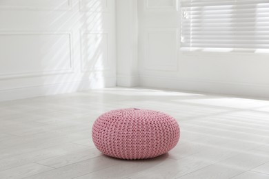 Stylish pink pouf in room. Home design