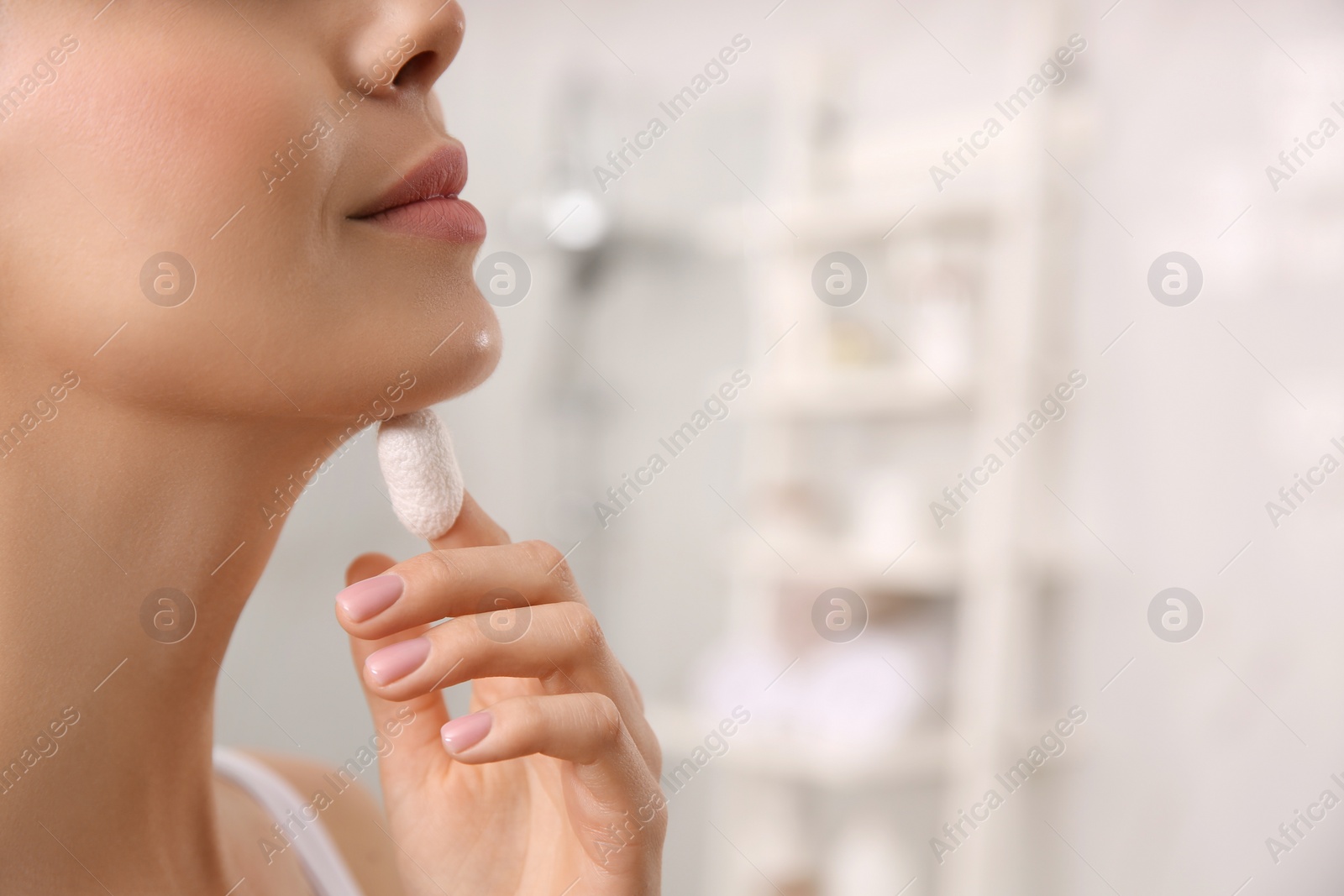 Photo of Woman using silkworm cocoon in skin care routine at home, closeup. Space for text