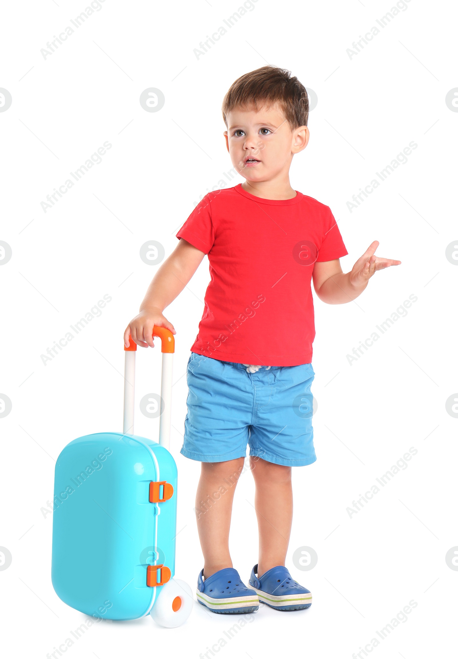 Photo of Cute little boy with blue suitcase on white background