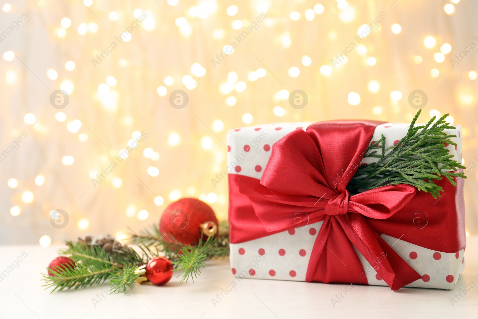 Photo of Christmas gift and decoration on table against blurred background