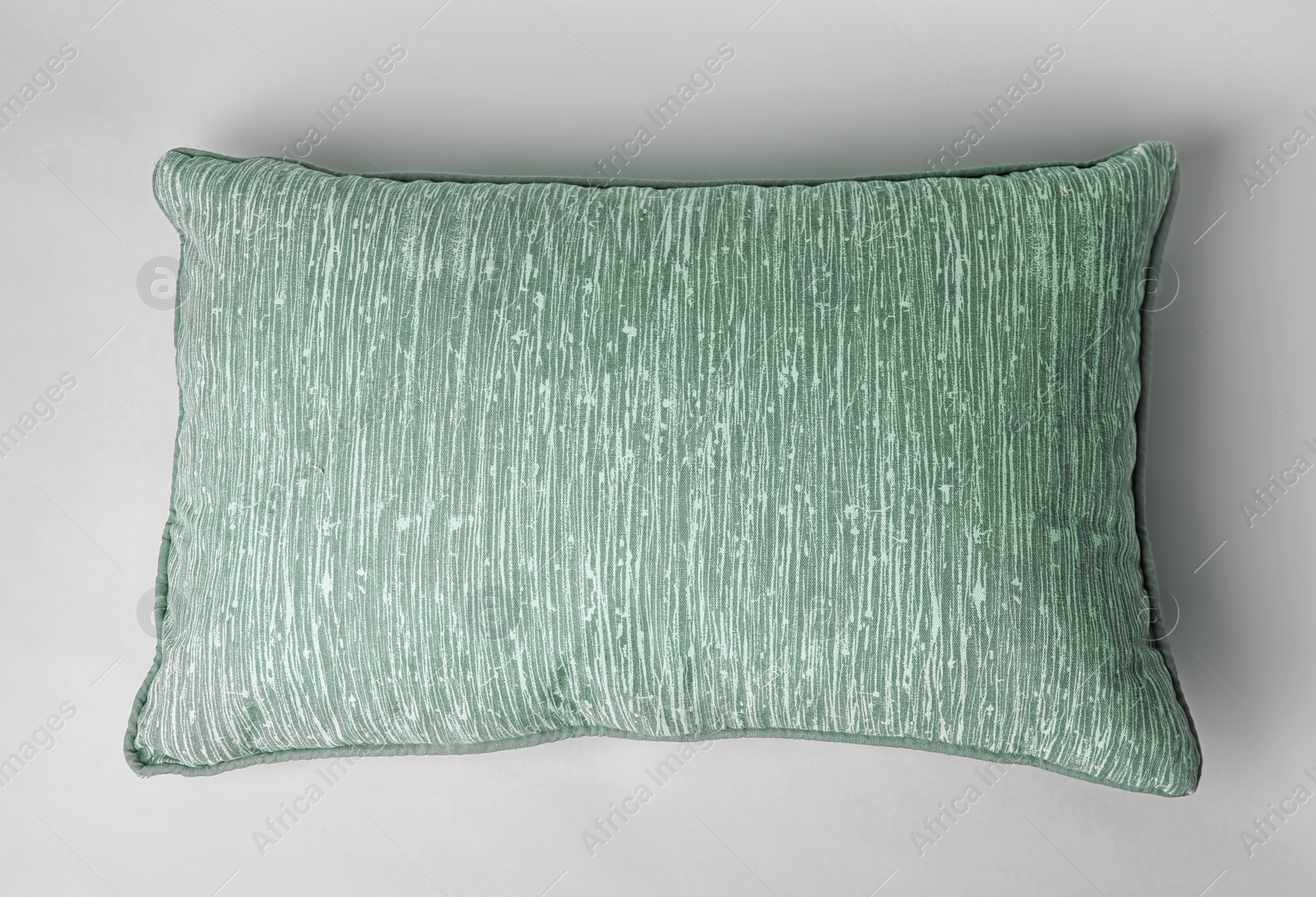 Photo of Soft decorative pillow on light background