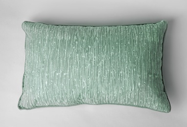 Photo of Soft decorative pillow on light background