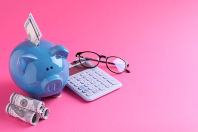 Financial savings. Piggy bank, dollar banknotes, glasses and calculator on pink background, space for text