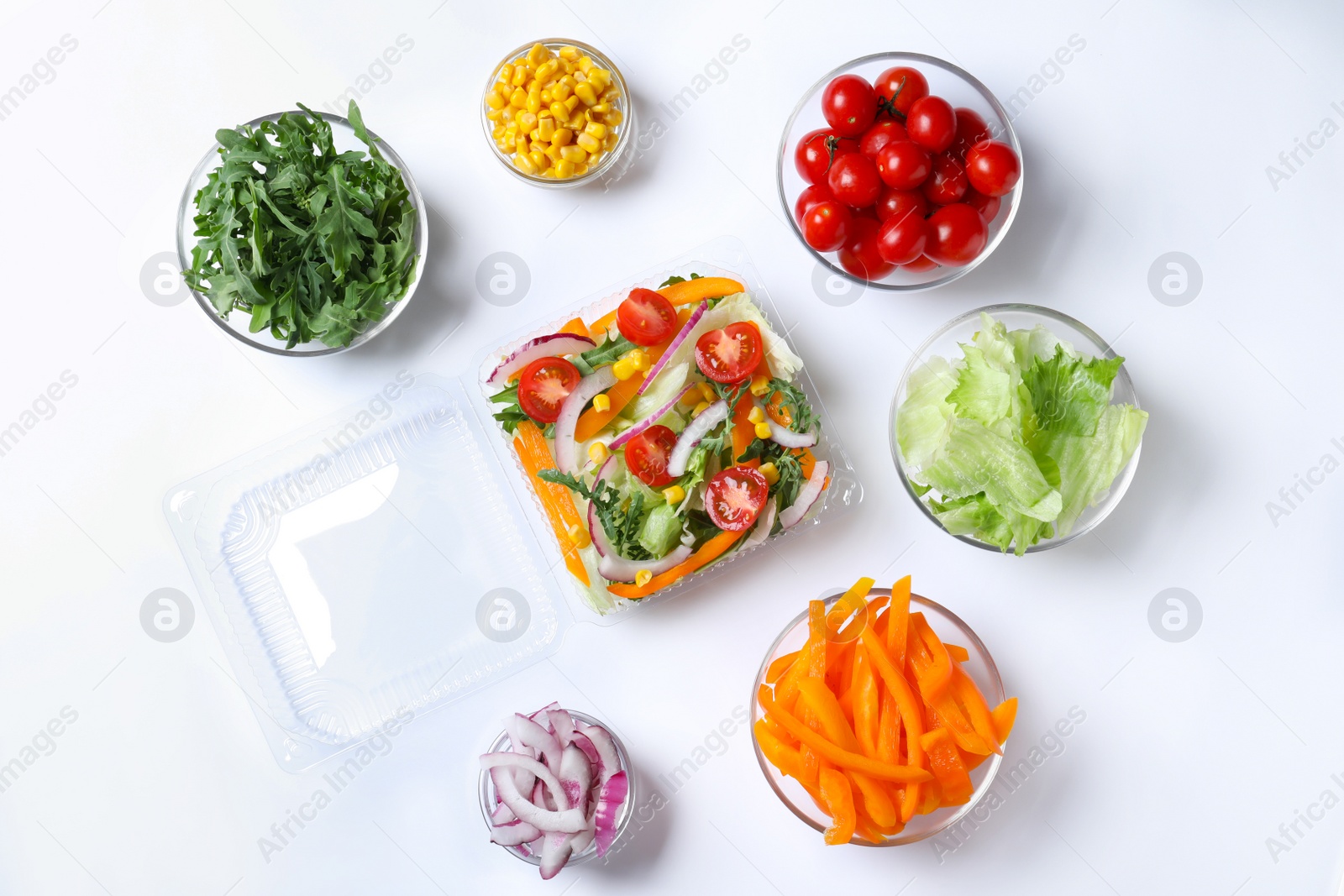 Photo of Fresh salad and ingredients on white background, top view