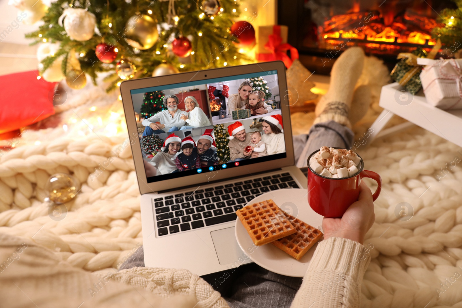 Image of Young woman having online meeting with family members via videocall application at home, closeup