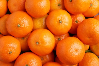 Delicious fresh tangerines as background, top view