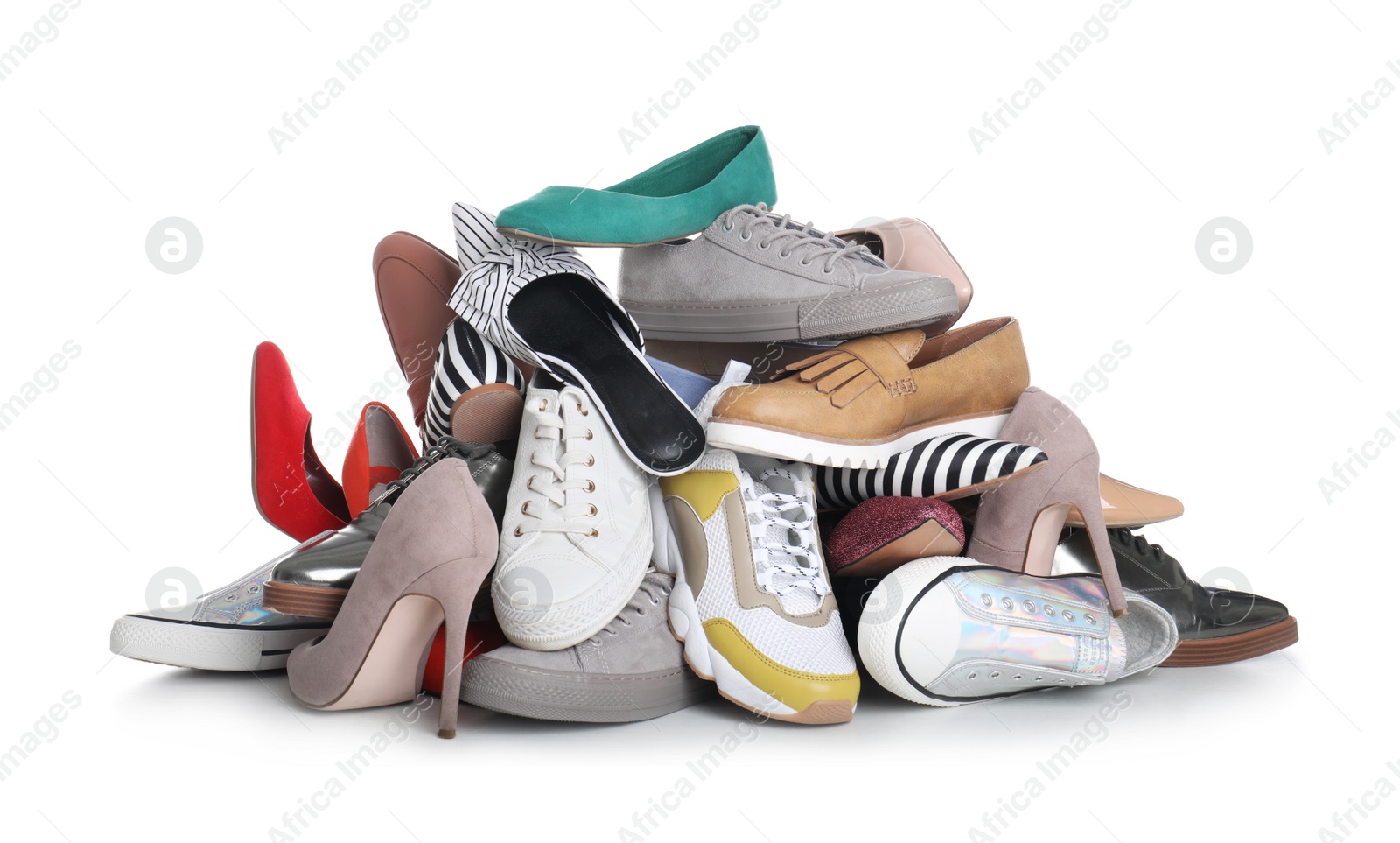 Photo of Pile of female shoes on white background