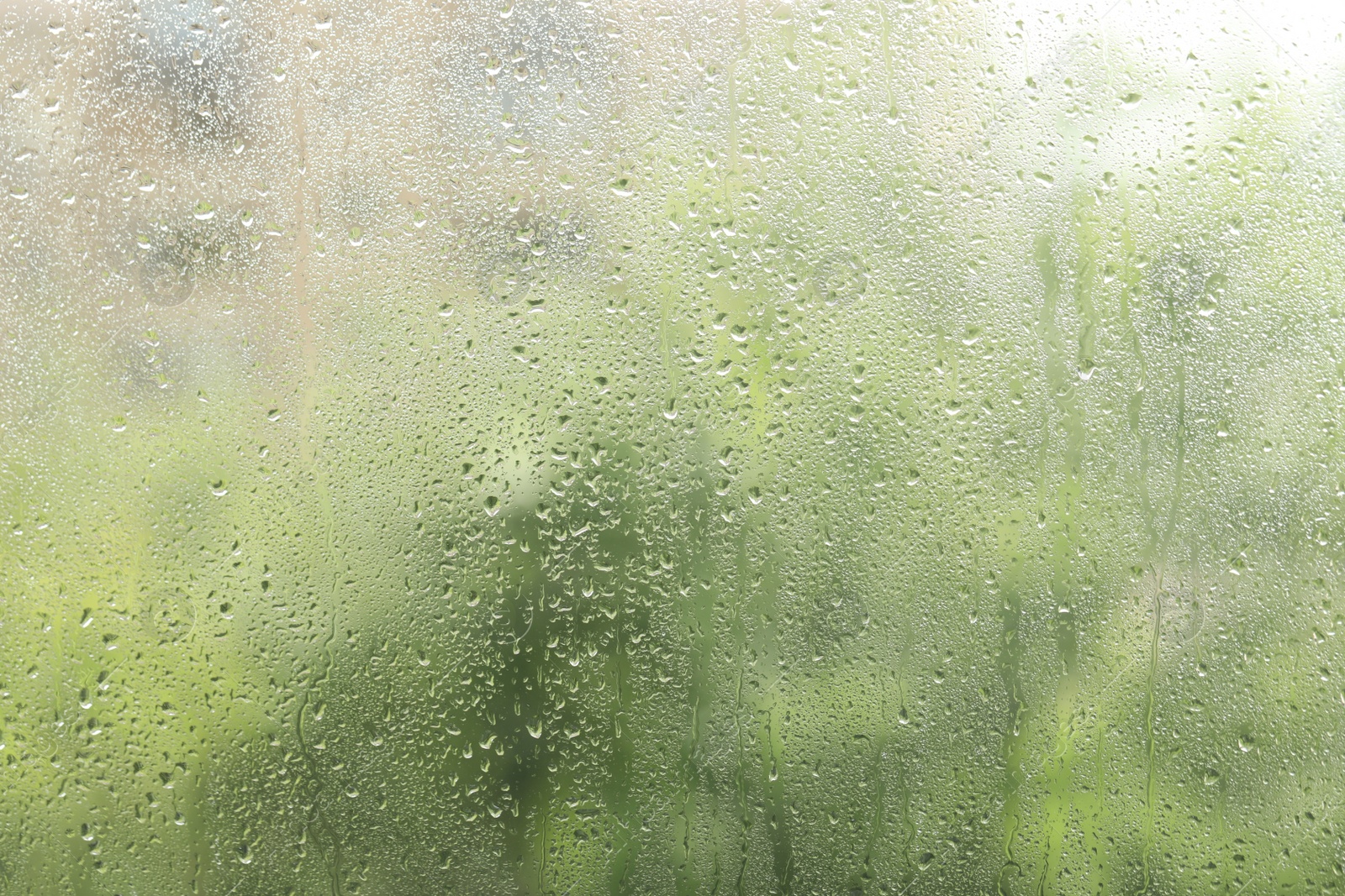 Photo of Window glass with raindrops as background, closeup