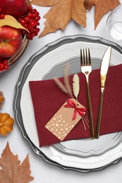 Elegant festive setting with autumn decor on table, flat lay