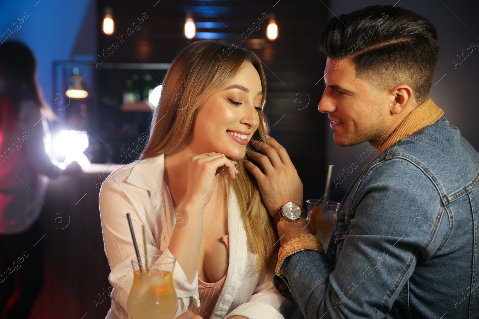 Photo of Man and woman flirting with each other in bar