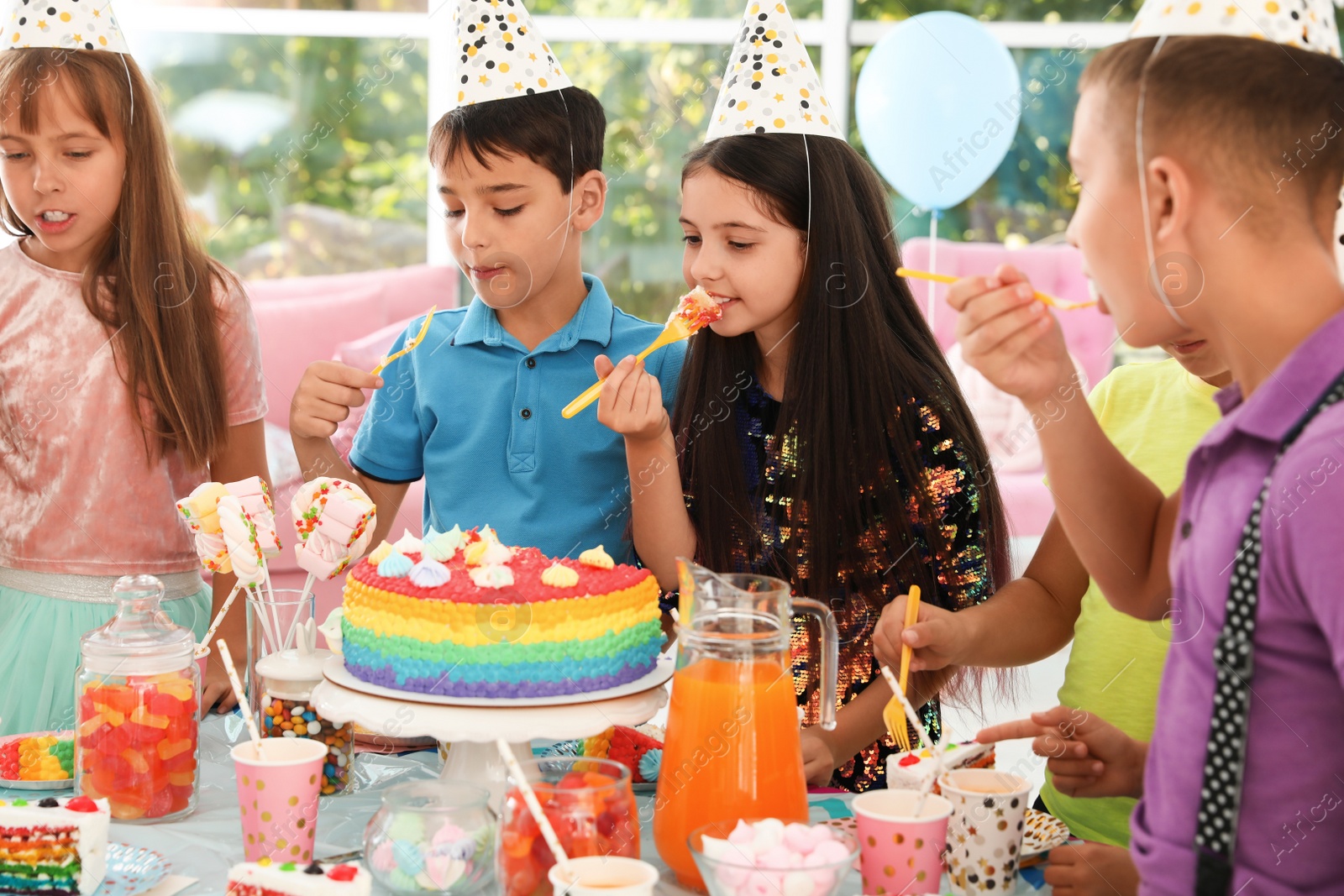 Photo of Happy children eating delicious cake at birthday party indoors