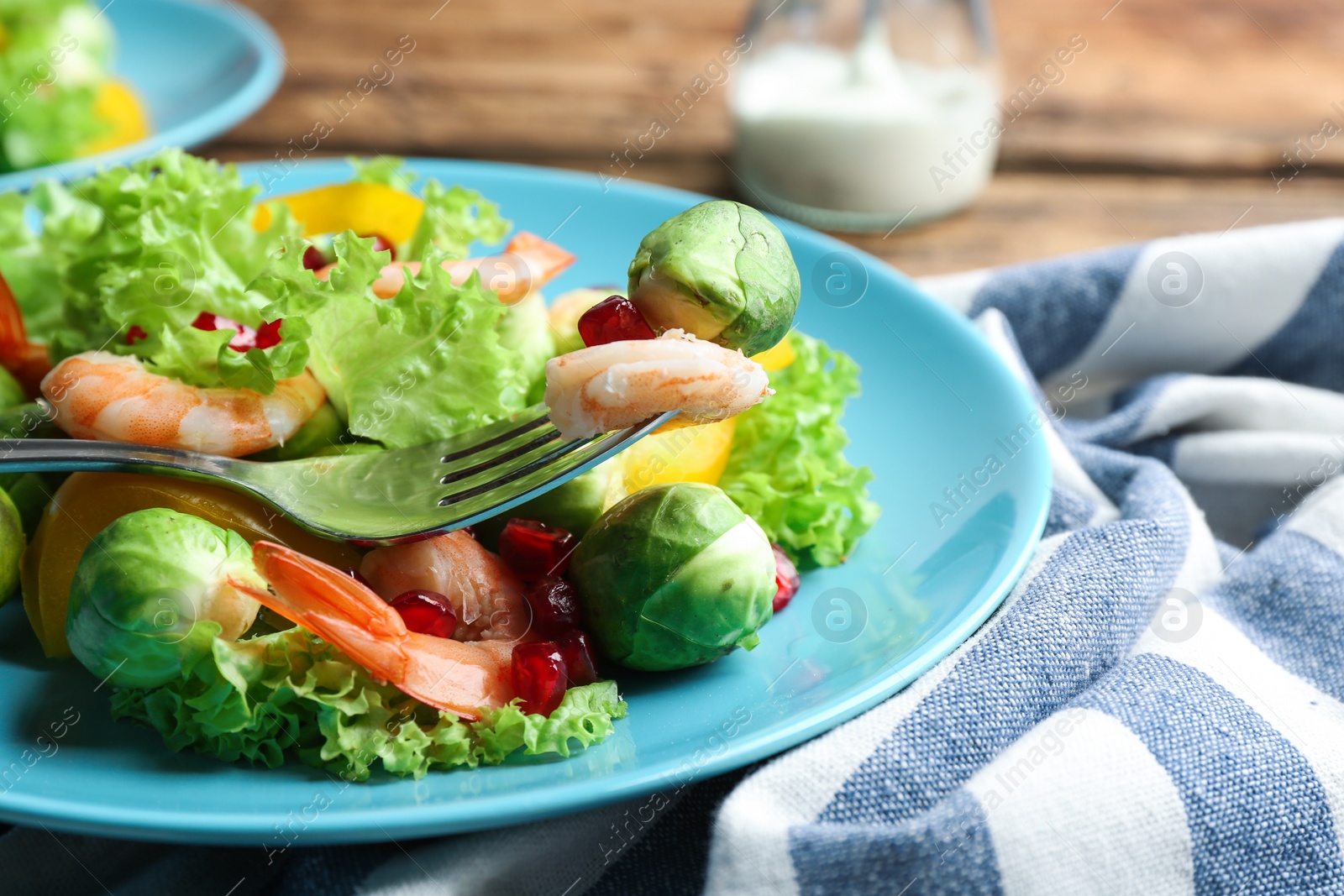 Photo of Tasty salad with Brussels sprouts served on table, closeup