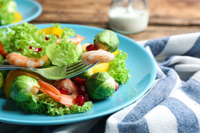 Photo of Tasty salad with Brussels sprouts served on table, closeup