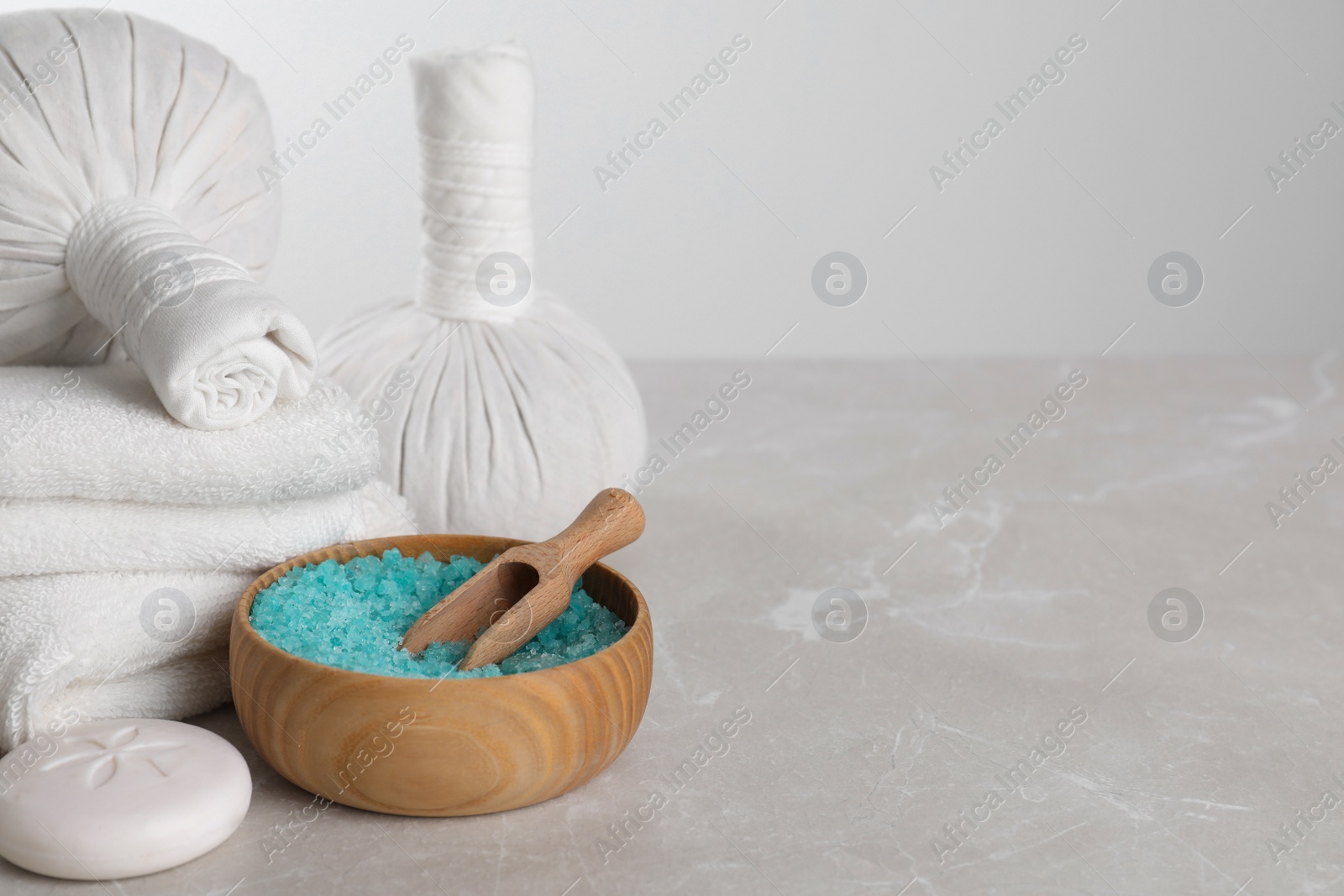 Photo of Spa composition with care products on light grey marble table. Space for text