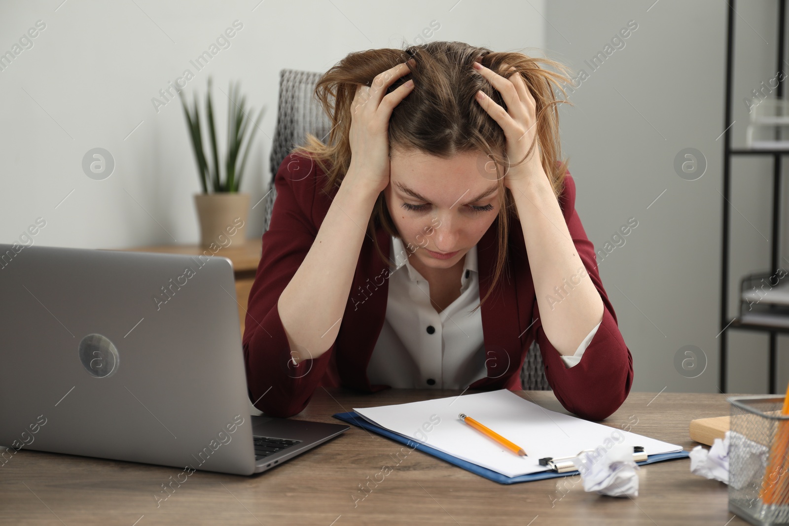 Photo of Sad businesswoman working at wooden table in office