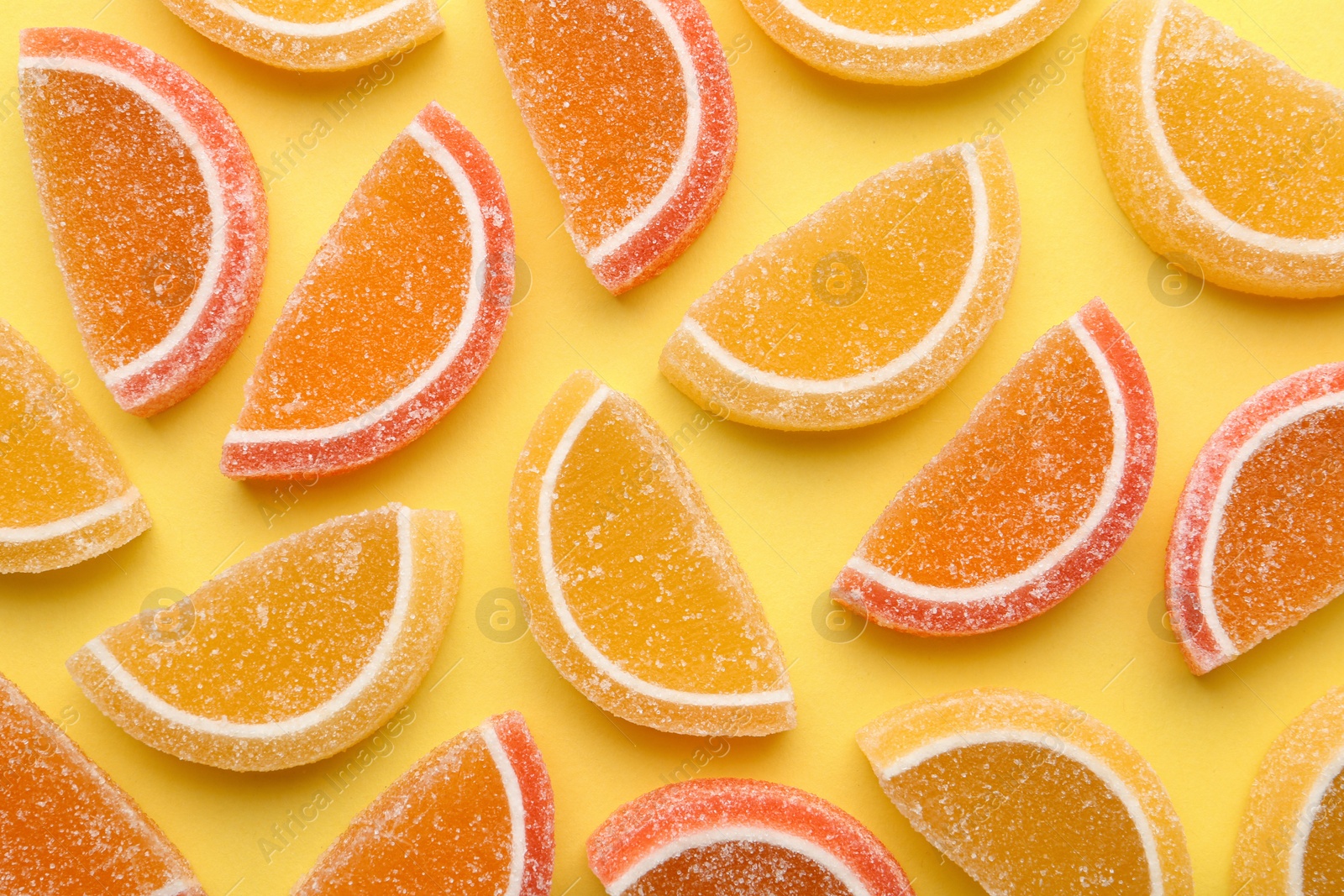 Photo of Tasty jelly candies on color background, flat lay