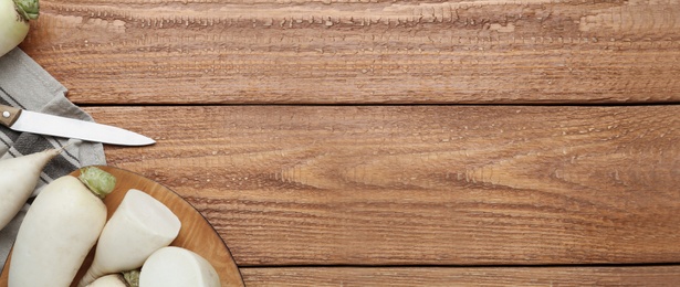 Image of White turnips on wooden table, flat lay. Space for text