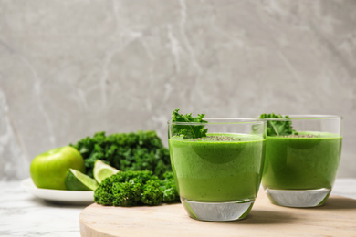 Tasty kale smoothie with chia seeds on marble table