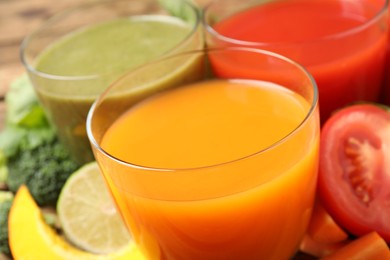 Delicious vegetable juices and fresh ingredients on table, closeup