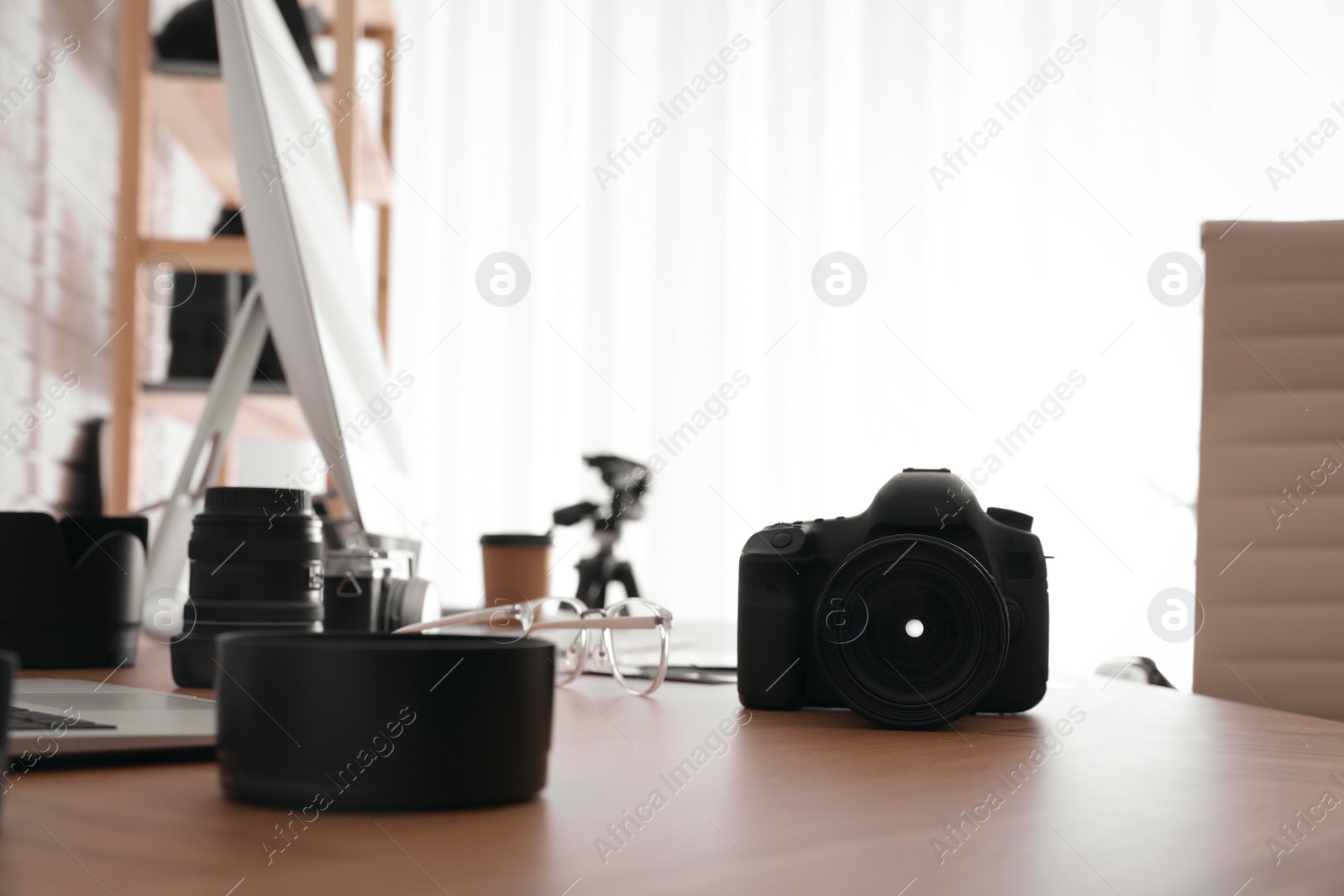 Photo of Photographer's workplace with professional camera in office