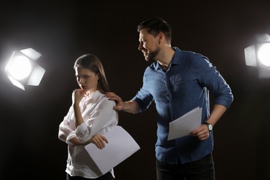 Professional actors rehearsing on stage in theatre