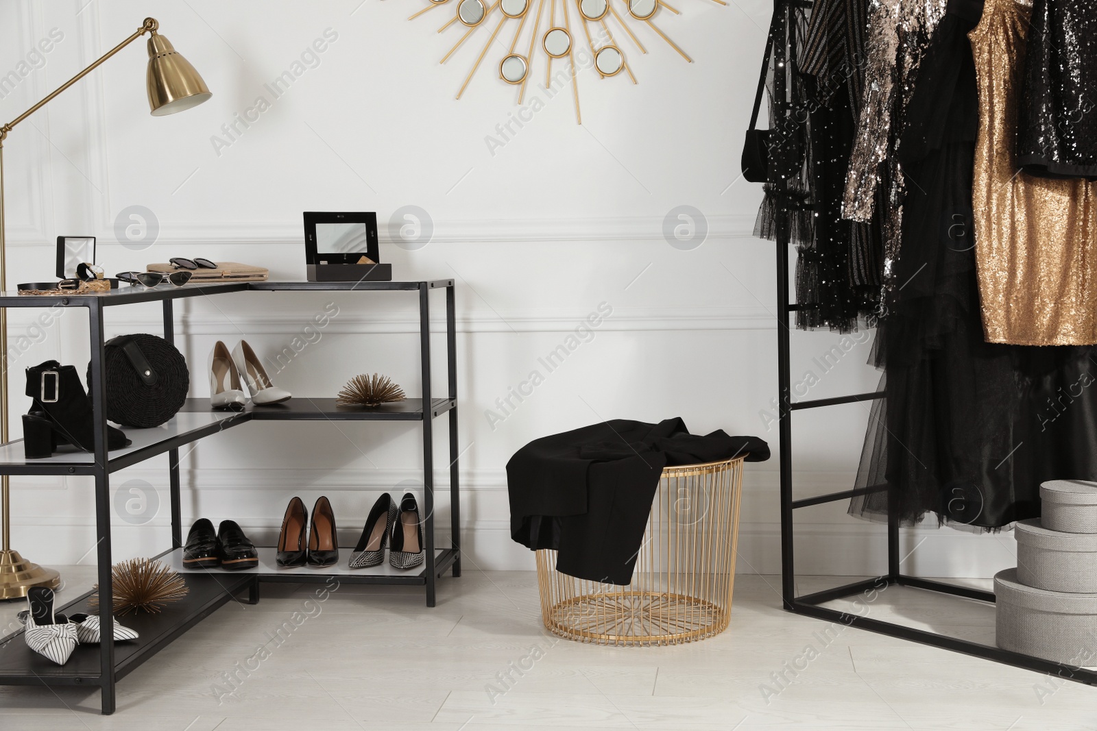 Photo of Rack with stylish women's clothes and accessories in dressing room