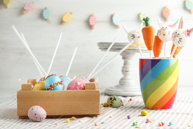 Photo of Different delicious sweet cake pops on table. Easter holiday
