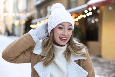 Portrait of smiling woman on city street in winter