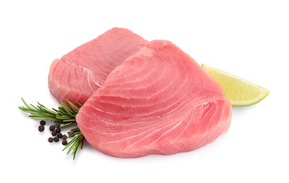 Fresh raw tuna fillets with peppercorns and rosemary on white background