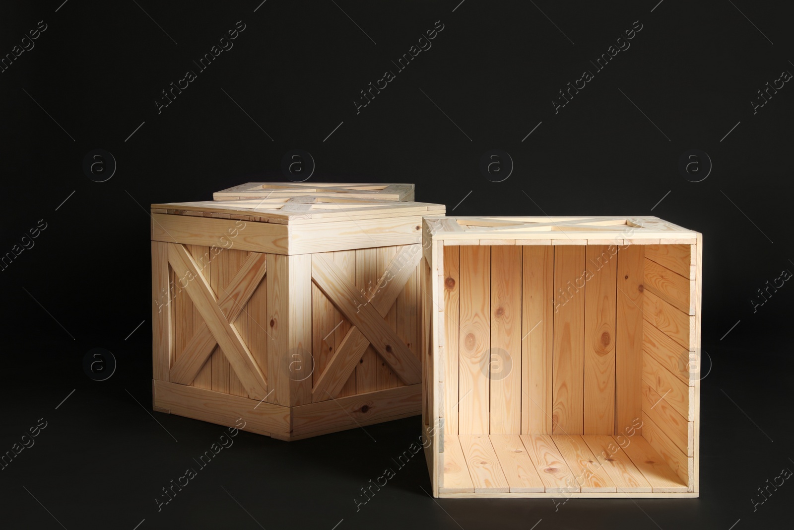 Photo of Group of wooden crates on black background