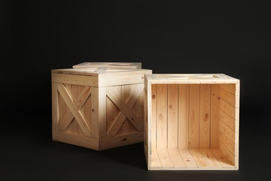 Photo of Group of wooden crates on black background