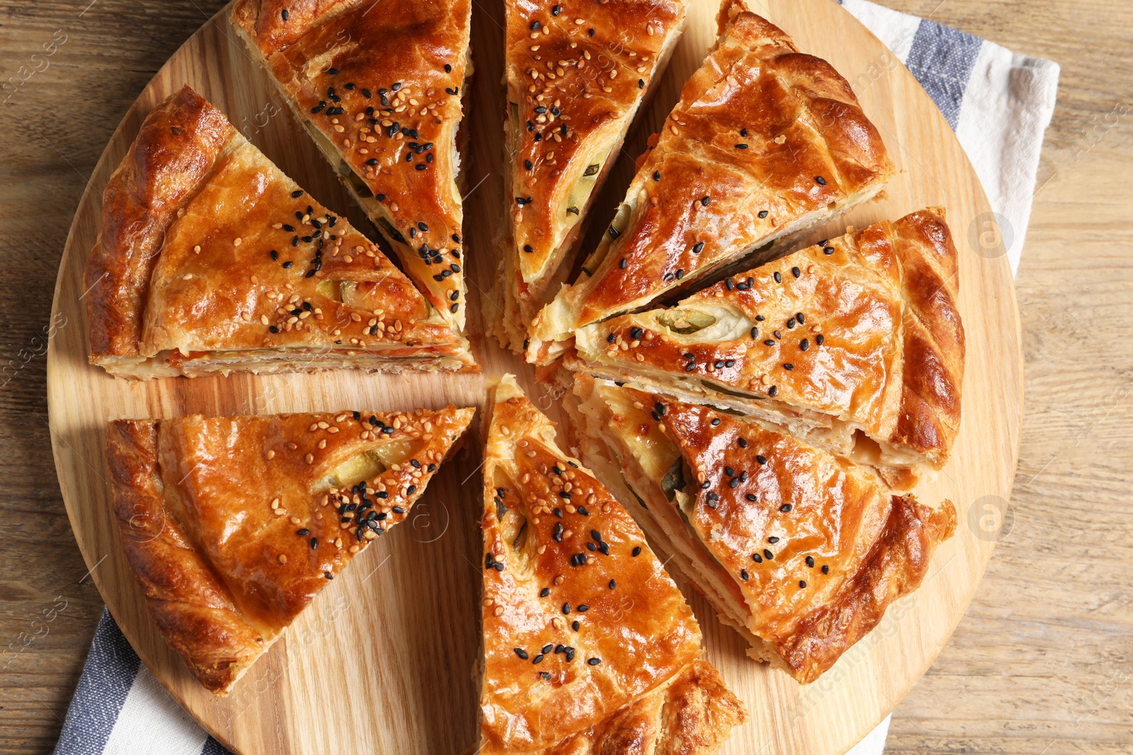 Photo of Cut delicious homemade pie on wooden table, top view