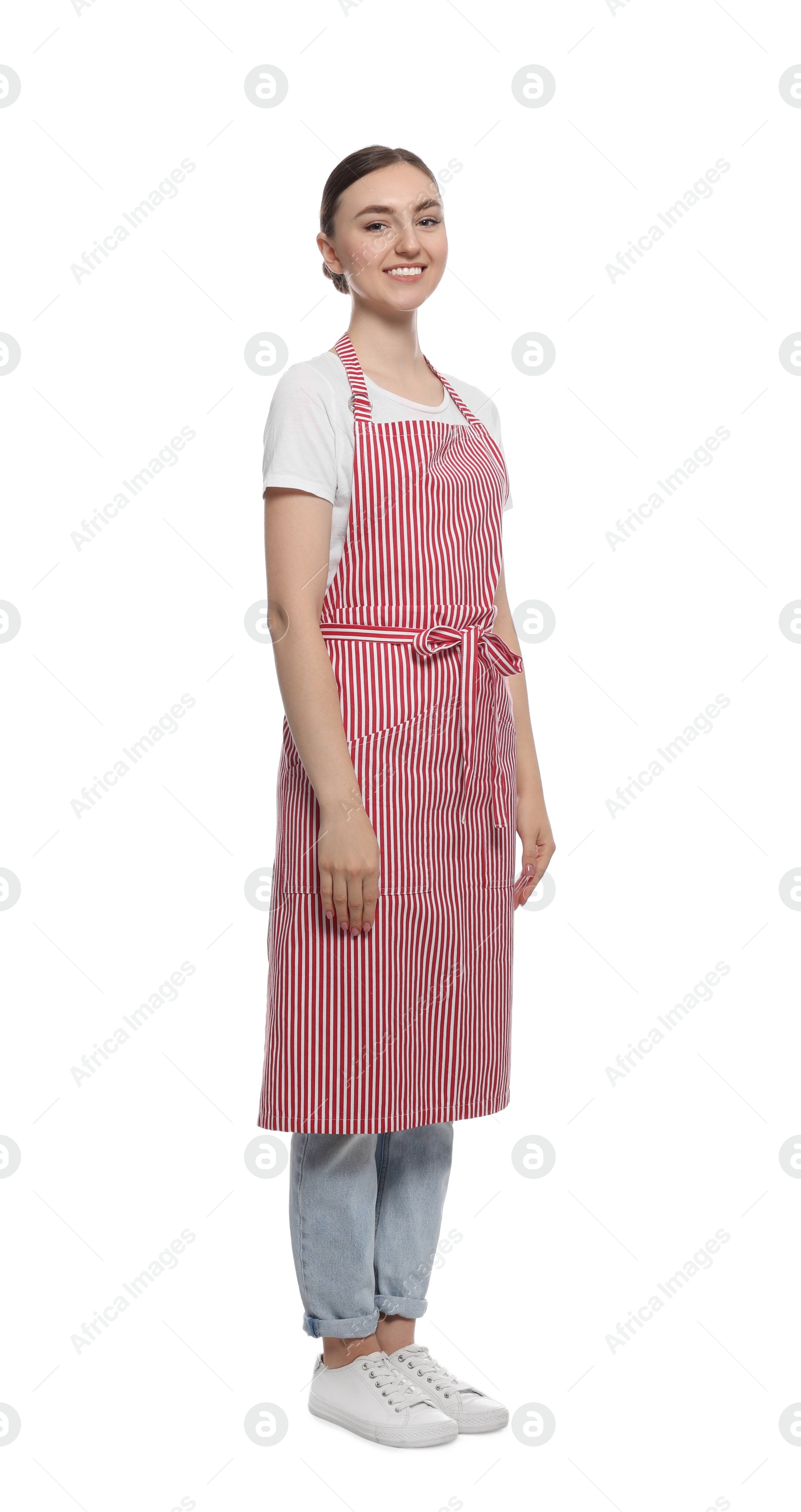 Photo of Beautiful young woman in clean striped apron on white background