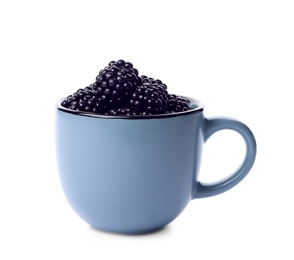 Photo of Blue cup of tasty blackberries on white background