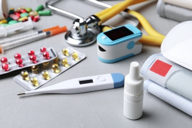 Set of medical objects on grey table