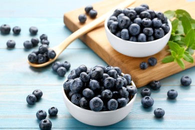 Photo of Tasty fresh blueberries on light blue table