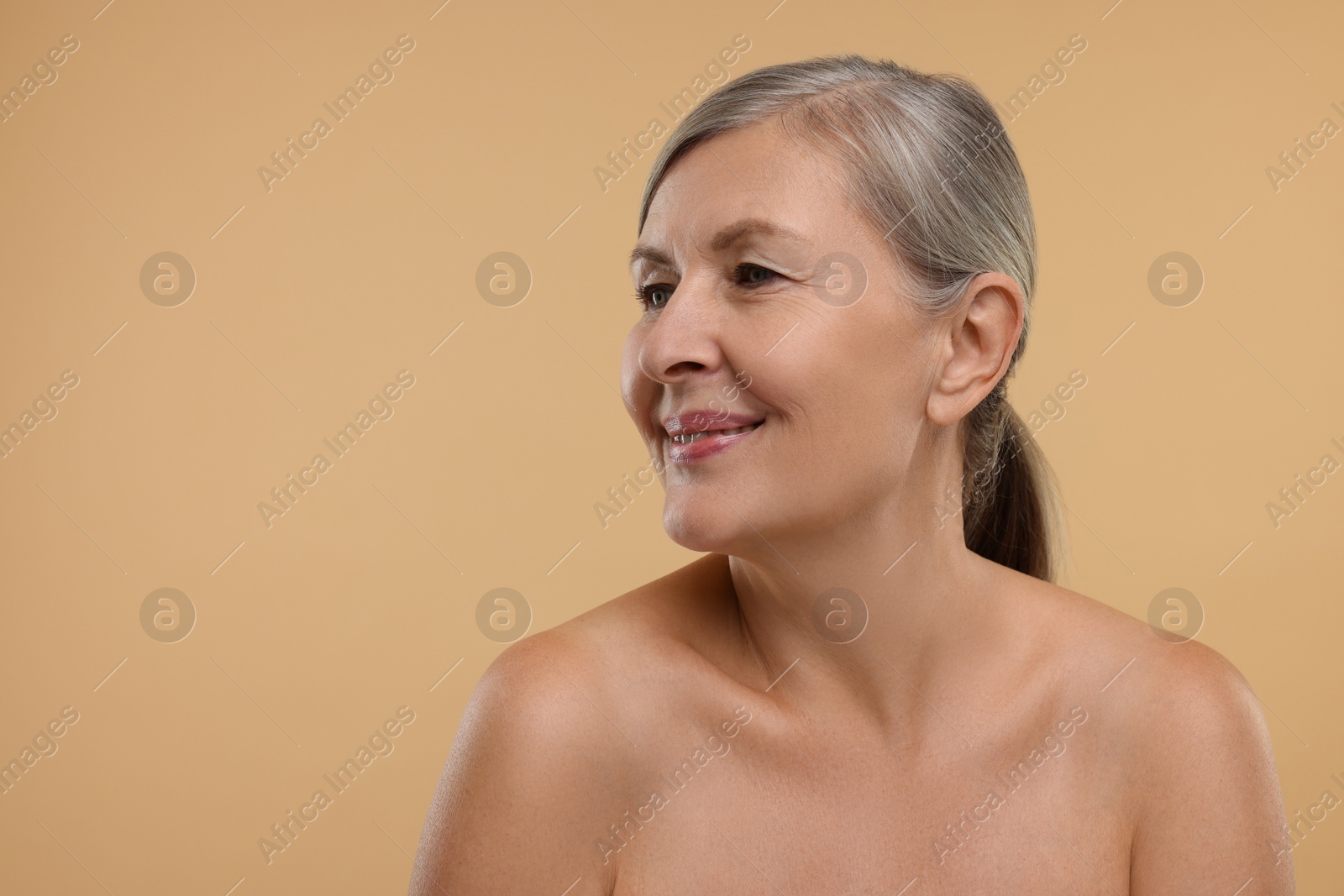 Photo of Beautiful woman with healthy skin on beige background, space for text