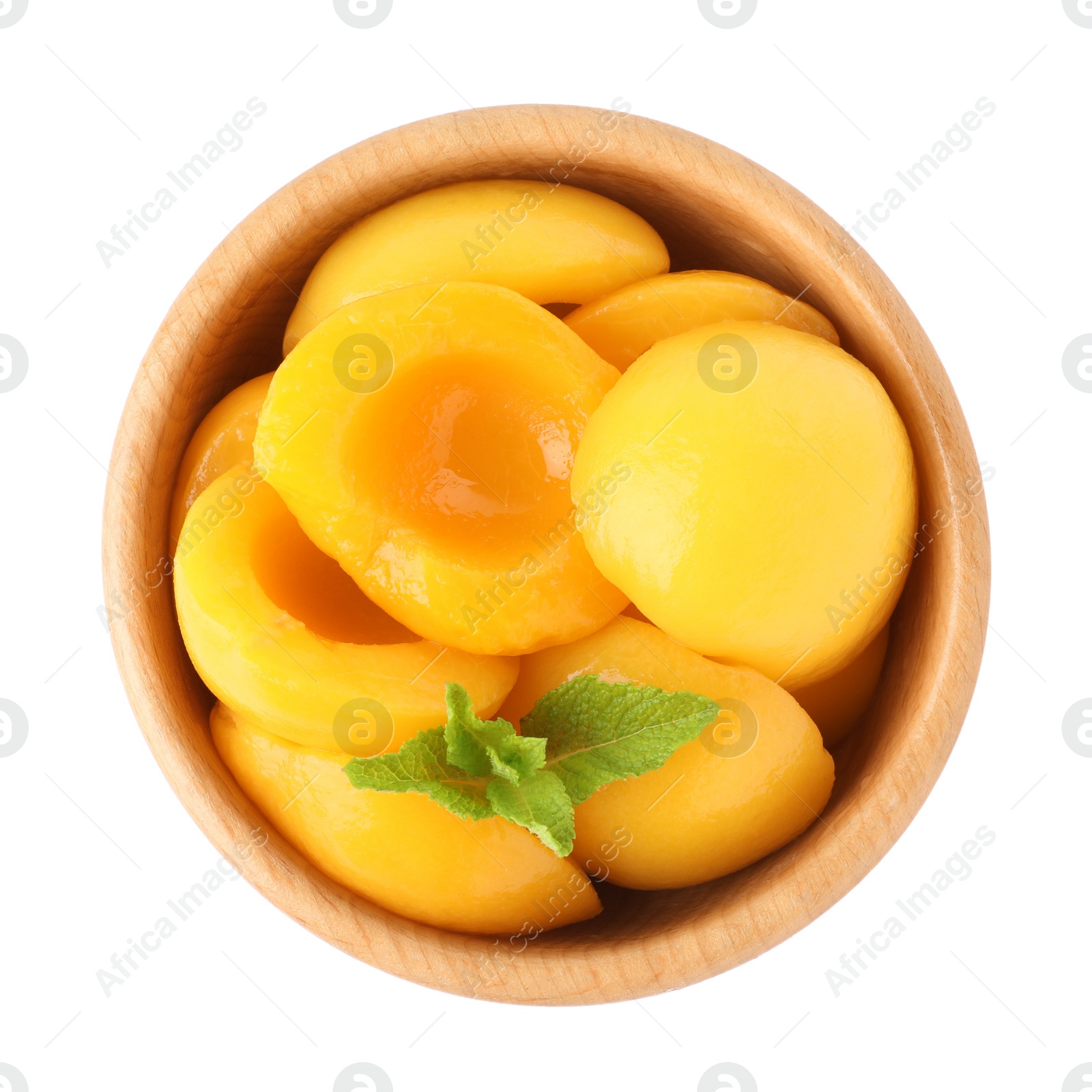 Photo of Halves of canned peaches with mint leaves isolated on white, top view