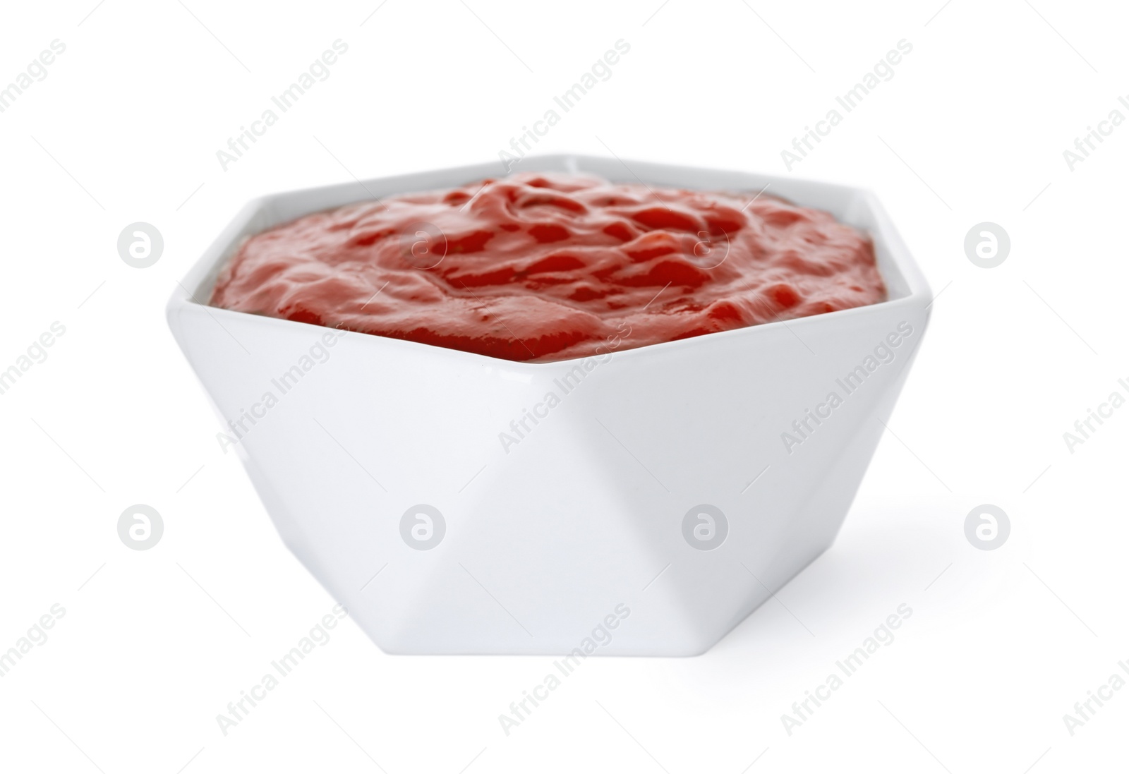 Photo of Bowl with red sauce isolated on white