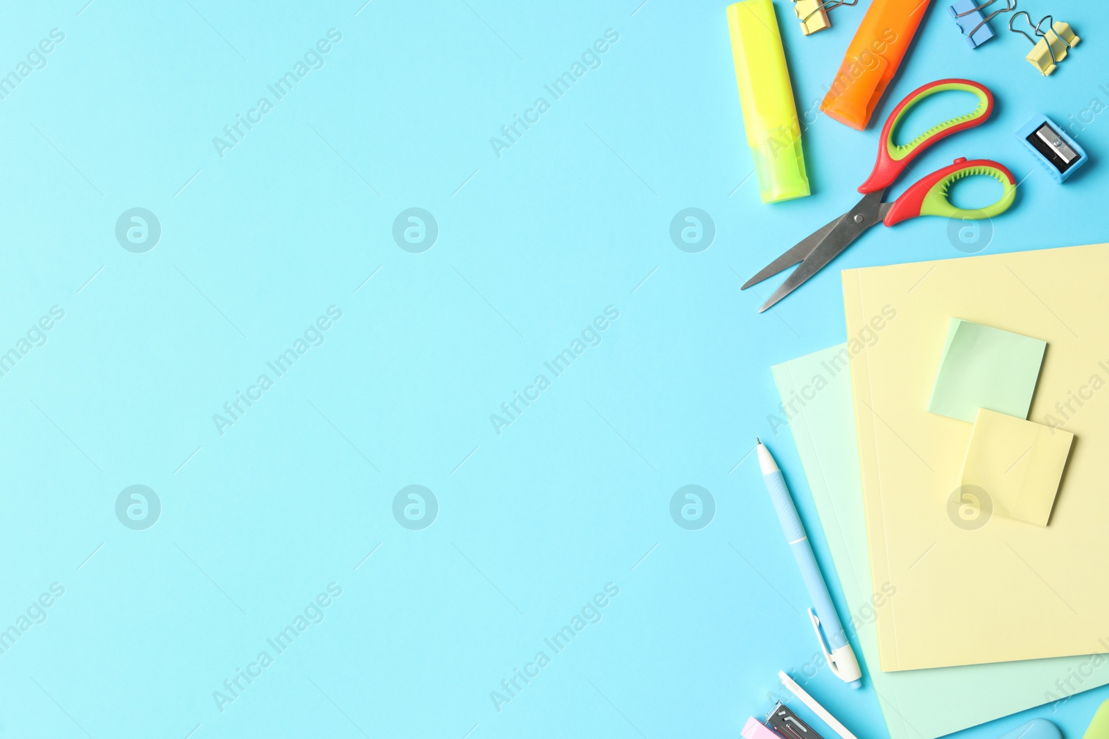 Photo of Flat lay composition with different school stationery on light blue background, space for text. Back to school