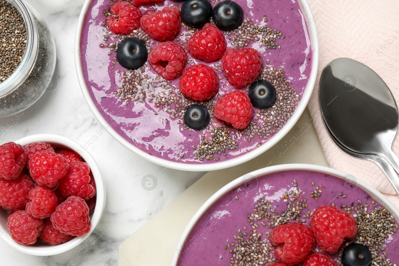 Photo of Delicious acai smoothie with fruits served on white marble table, flat lay