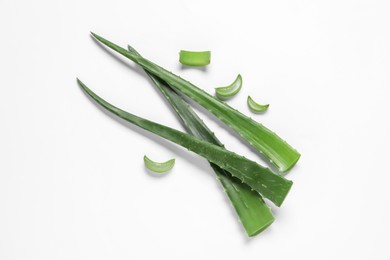 Cut aloe vera leaves on white background, flat lay