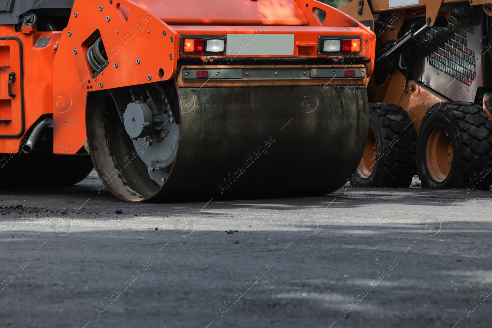 Photo of Modern roller on city street, closeup. Road repair service