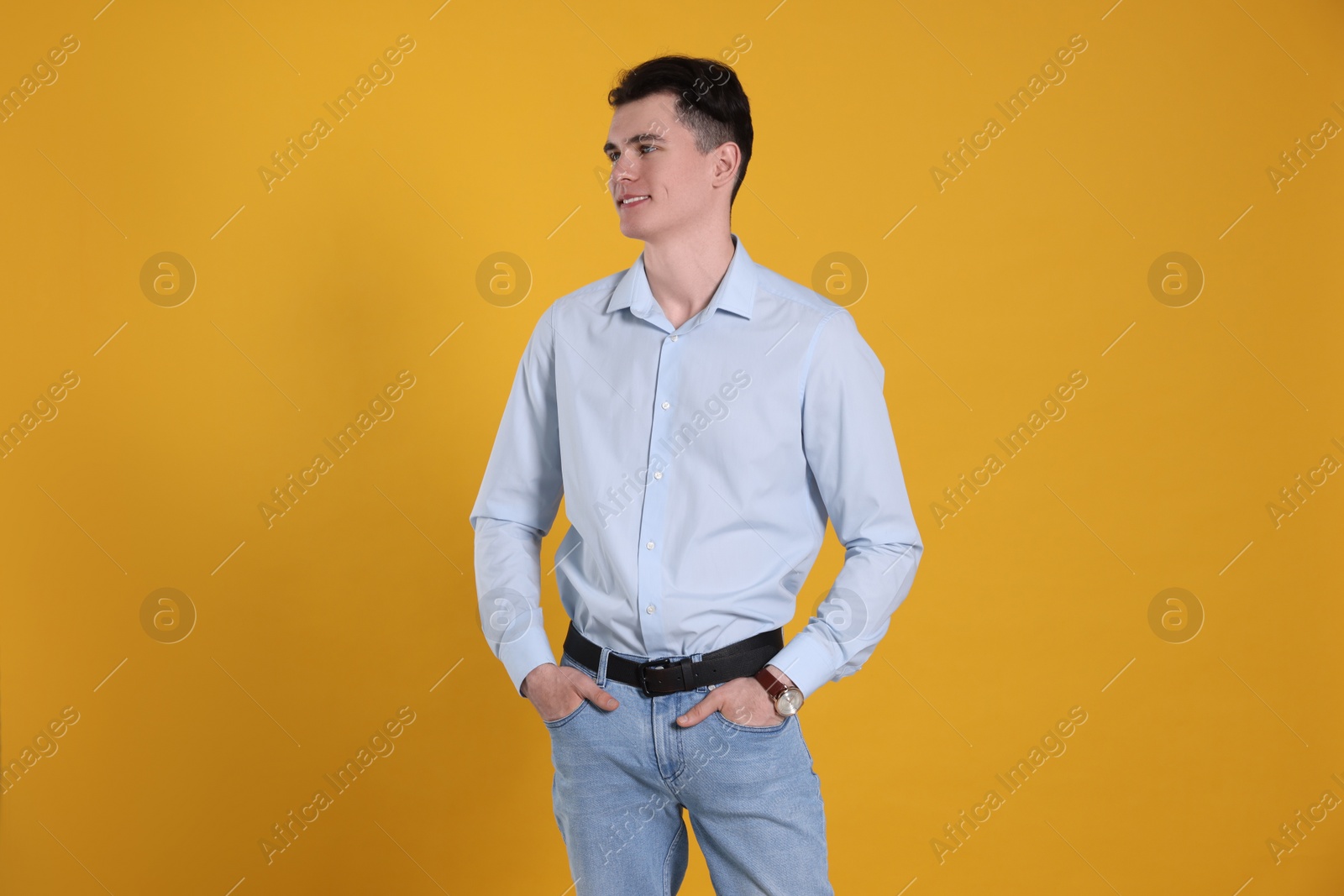 Photo of Portrait of happy young man on yellow background