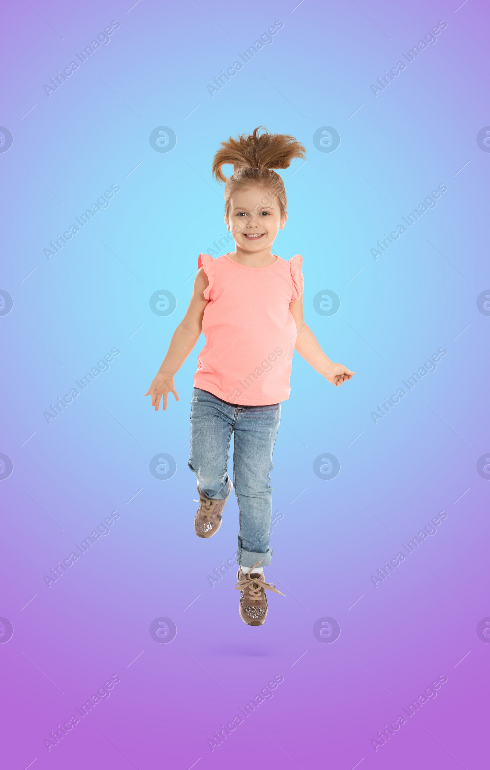 Image of Happy cute girl jumping on color gradient background