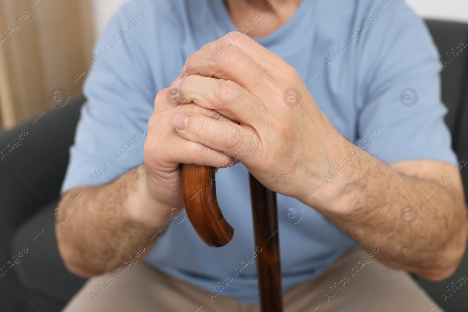 Photo of Senior man with walking cane at home, closeup