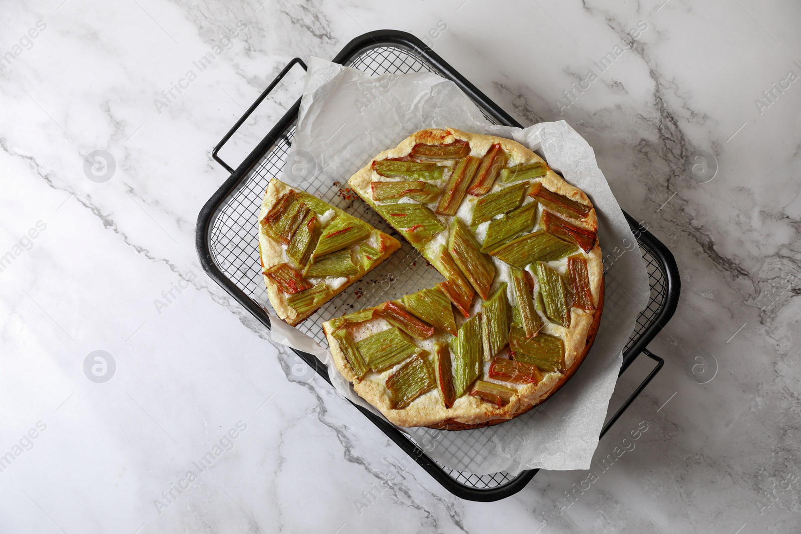 Photo of Freshly baked rhubarb pie on white marble table, top view